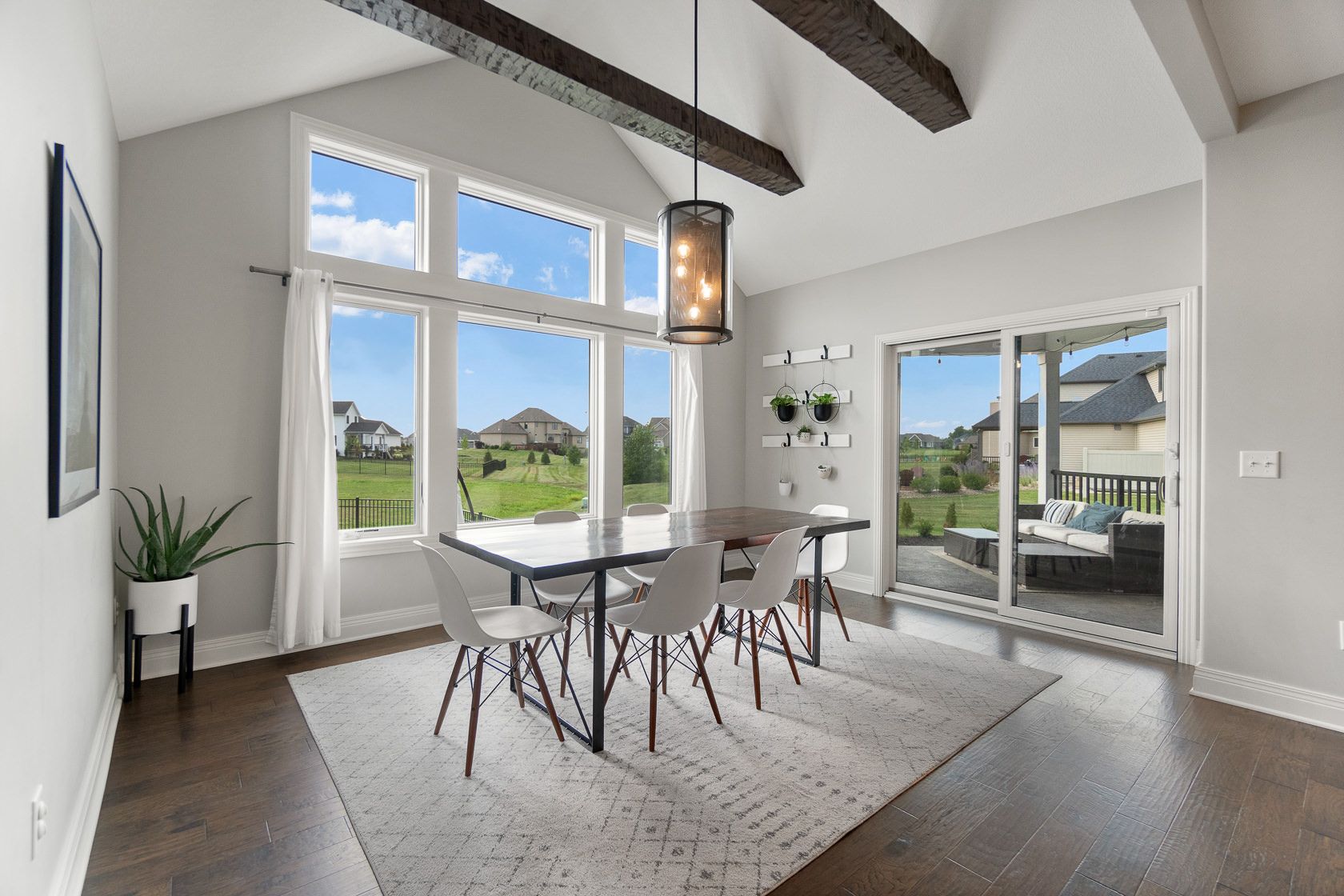 Dining area with vaulted beamed ceiling and wall of windows