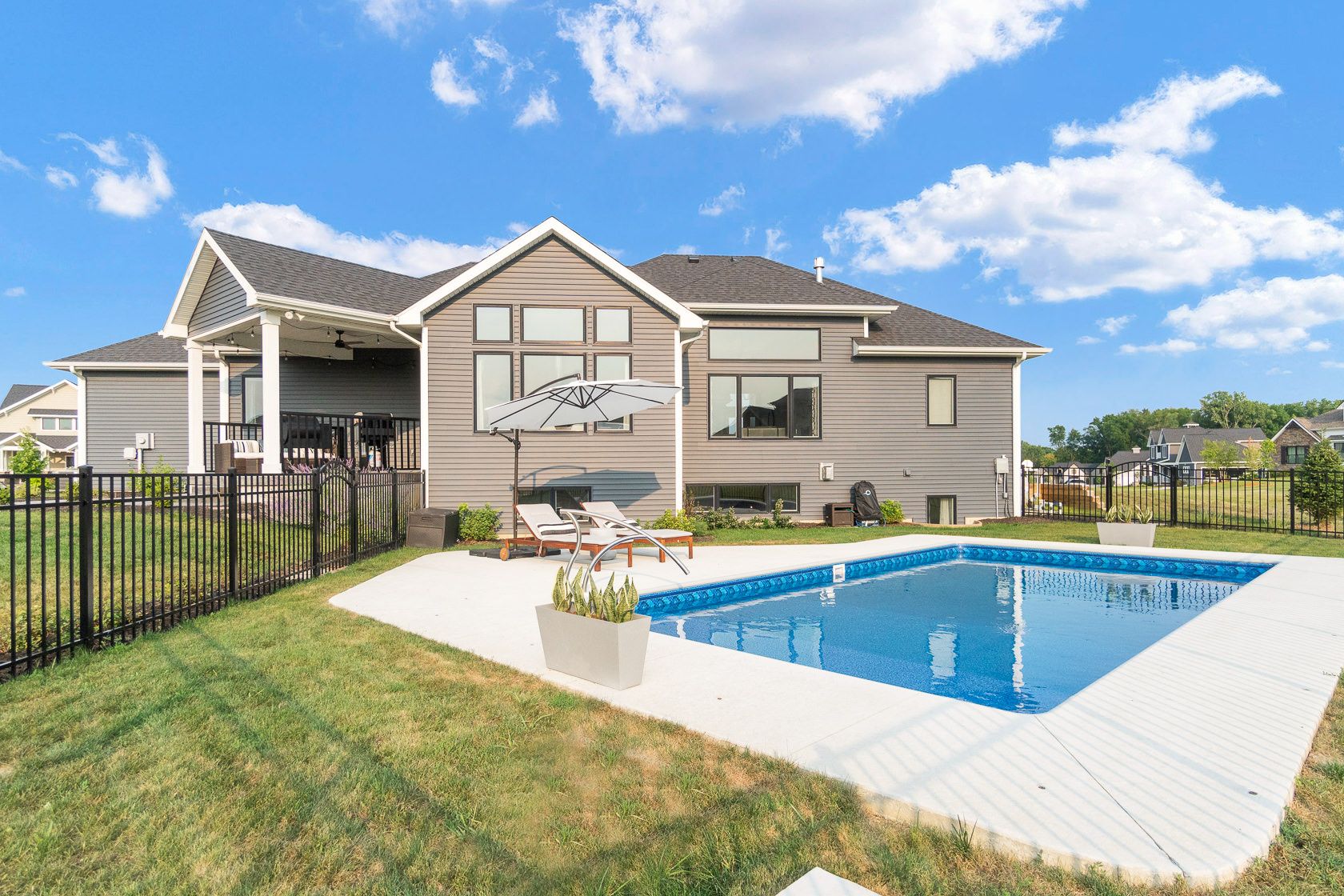 Back yard with in-ground pool and covered deck