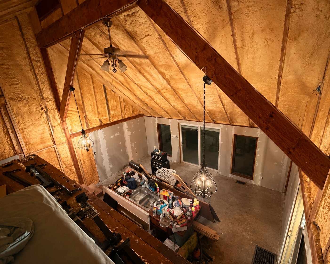 The loft space before: open rafters and exposed insulation