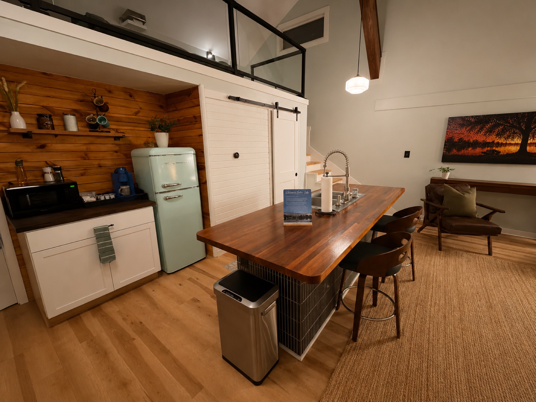 Kitchen with mint retro refrigerator, coffee bar, and a long butcher-block island