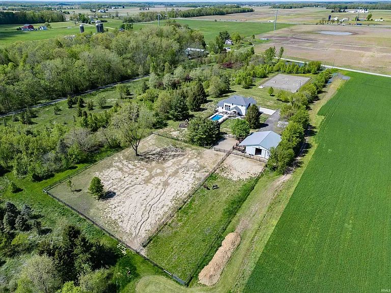 Aerial view of the estate: house, pool, barn and riding arena on five acres