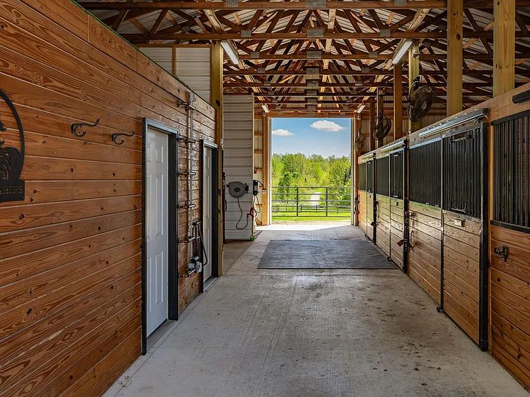 Inside the barn: oversized stalls down a wide centre aisle